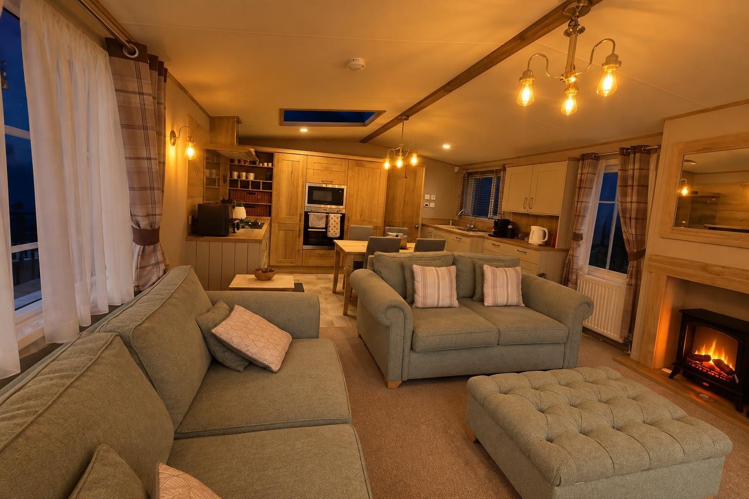 The open-plan lounge in the evening with the fire and chandelier on