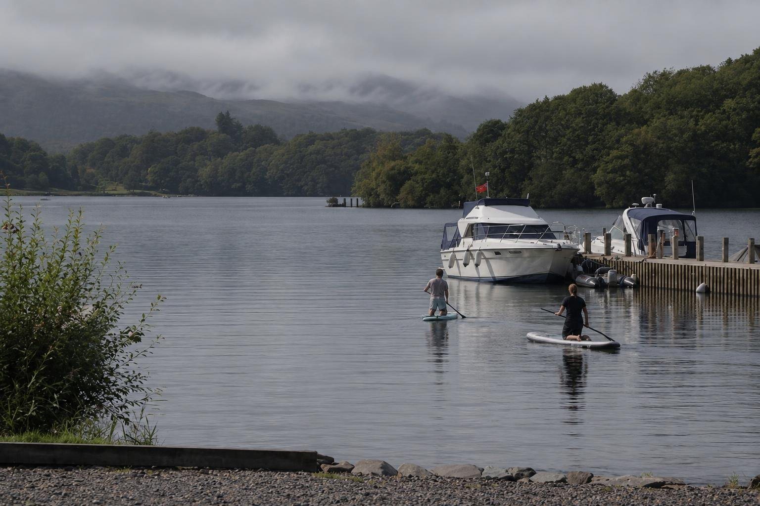 The lake, mist on the fells and two paddleboarders